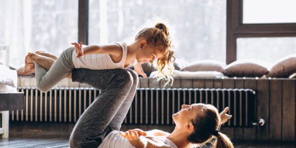 Mother and daughter yoga at home